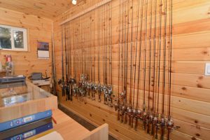 A wall of fishing rods available at our sport shop.