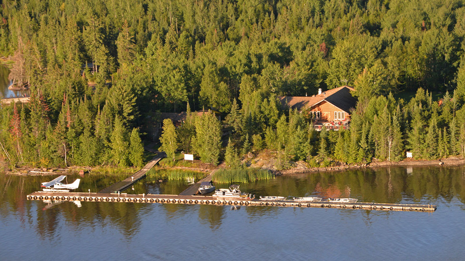 kettle-slider-1 Aerial view of the dock in front of the Lodge at Kettle Falls