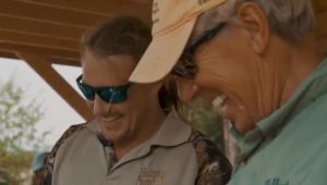 Our guides laughing while they prepare shore lunch