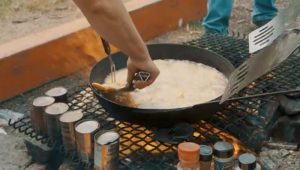 Walleye cooking on the pan over the fire