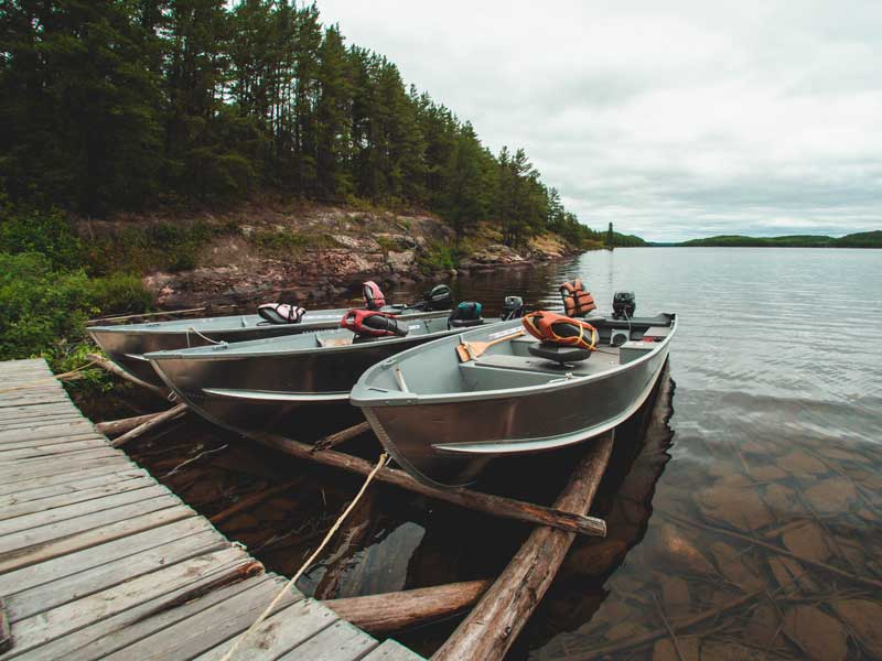 Three boats docked near shore.