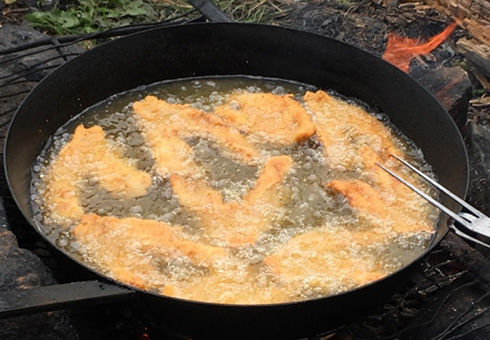 Walleye frying on the fire.