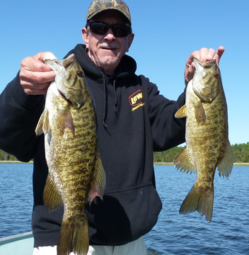 A pair of smallmouth bass in the boat