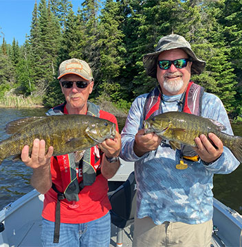Two of Halley's guests showing their small mouth bass.