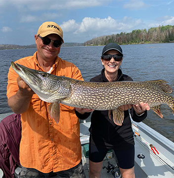 Trophy Northern Pike being held by two of Halley's guests