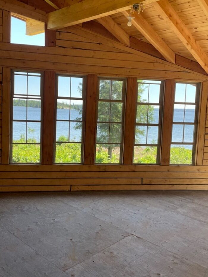 Looking out at the lake from inside a cabin that just had new windows installed