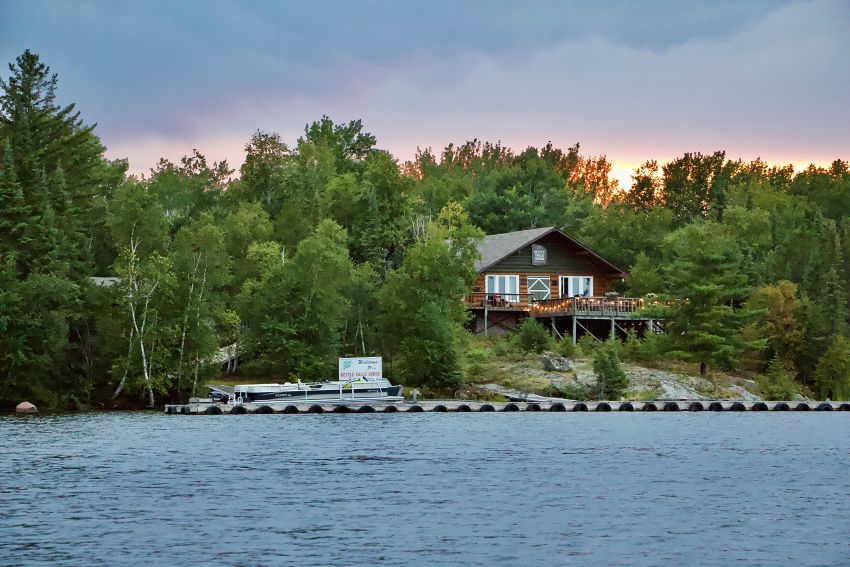 fishing lodge with twinkle lights at sunset