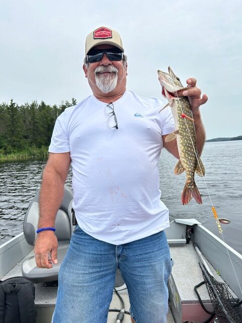 Man holding a smaller northern pike