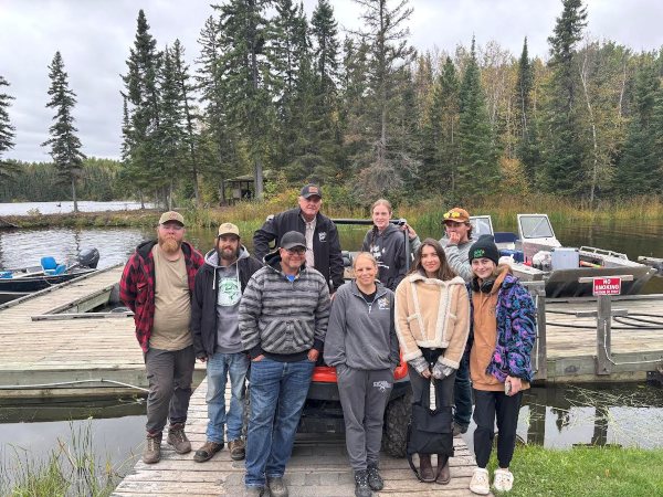 A group of employees from Halley's Camps Kettle Falls Lodge posing at the dock before they leave for the season after working all fishing season-4 months!