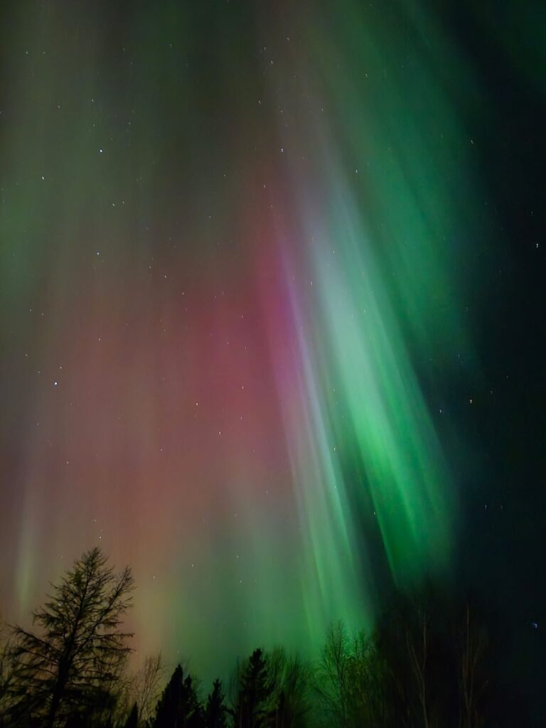 Northern lights shining in every color at One Man Lake Lodge across the skies